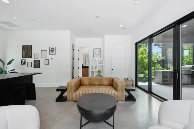 a view of a room with a large window and furniture