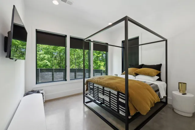 a living room with patio furniture and a floor to ceiling window