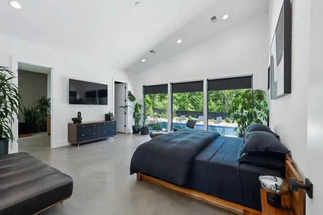 a living room with fireplace furniture and a large window