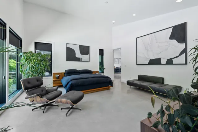 a living room with furniture potted plant and a large window