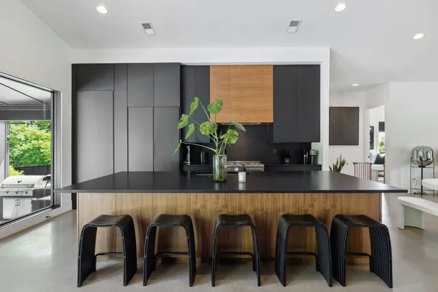 a view of a swimming pool with a yard and large tree