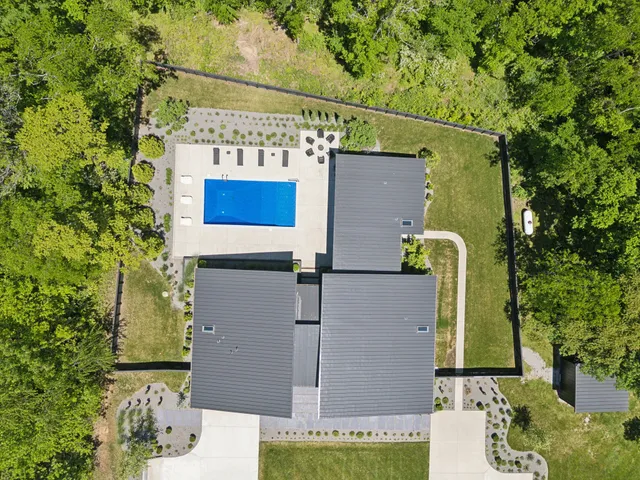 an aerial view of a house with a yard