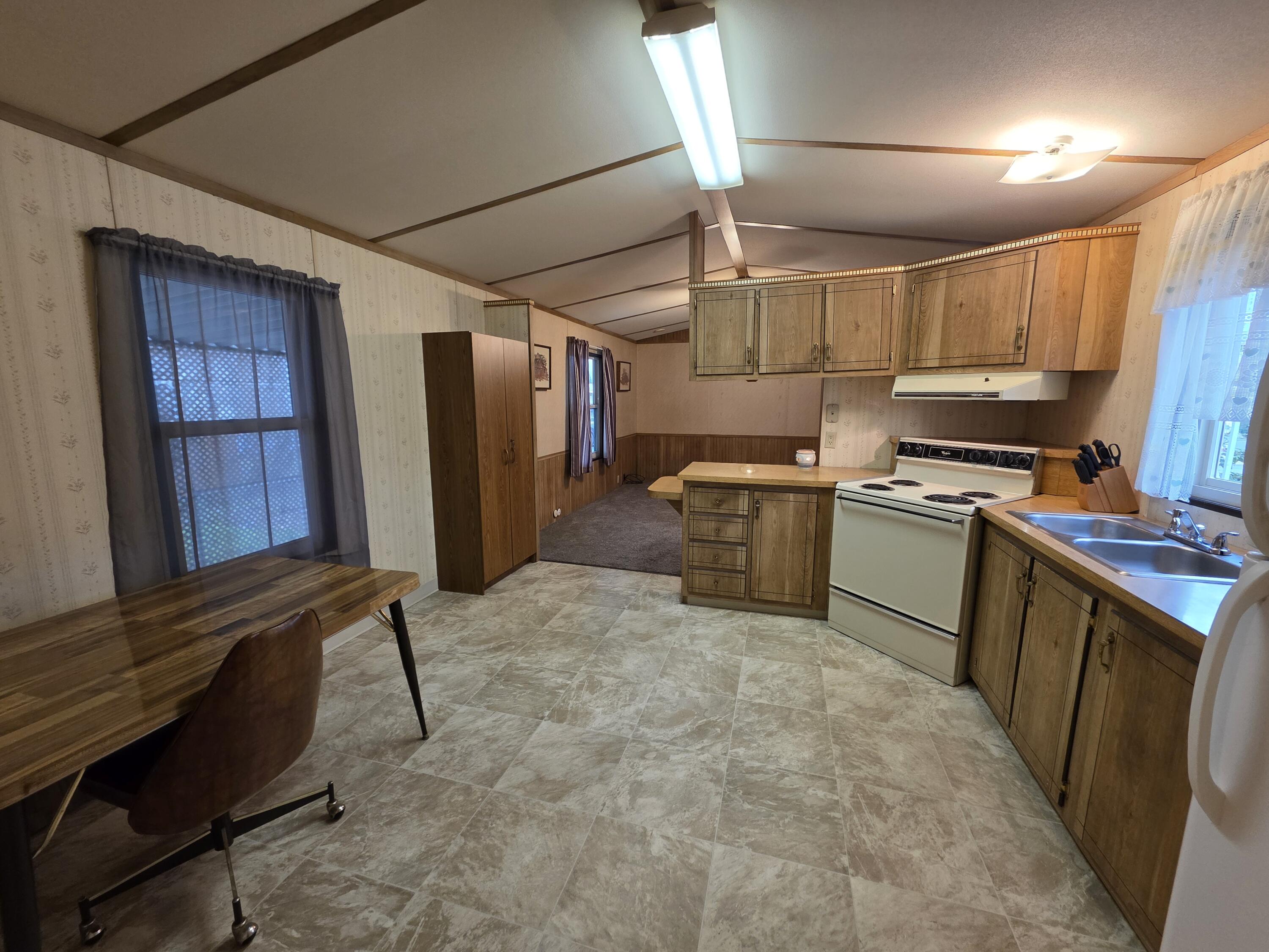301 Freeman Road, Unit 30 Central Point, OR 97502 - Photo 3 of 26 a kitchen with sink cabinets and window