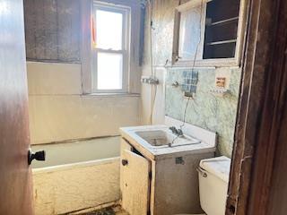 35-19 21st Avenue Queens, NY 11105 - Photo 3 of 6 a bathroom with a sink a toilet a mirror and window