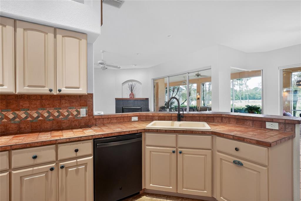 2968 Plantation Road Winter Haven, FL 33884 - Photo 20 of 81 a kitchen with granite countertop white cabinets white appliances and a sink