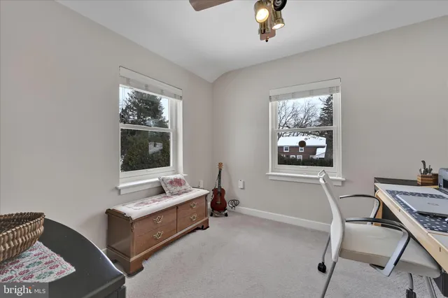 a view of workspace with a computer on a desk and chair