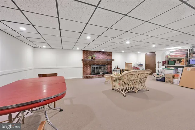 a dining hall with stainless steel appliances granite countertop a sink and a white cabinets