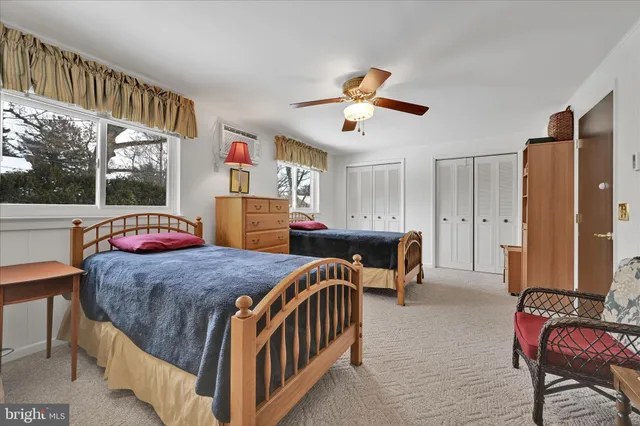 a bathroom with a granite countertop toilet sink and mirror