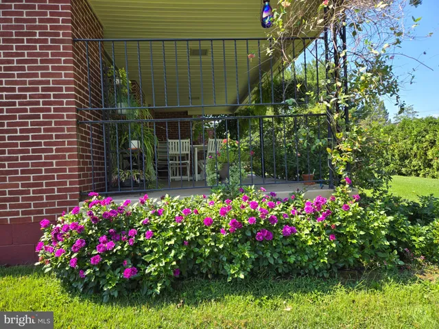 a view of balcony with outdoor seating and green space