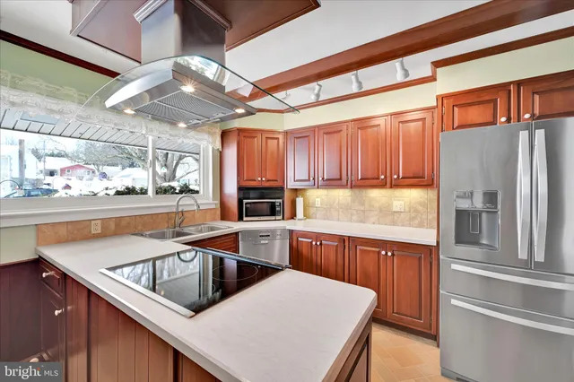 a kitchen that has a sink cabinets counter space and stainless steel appliances