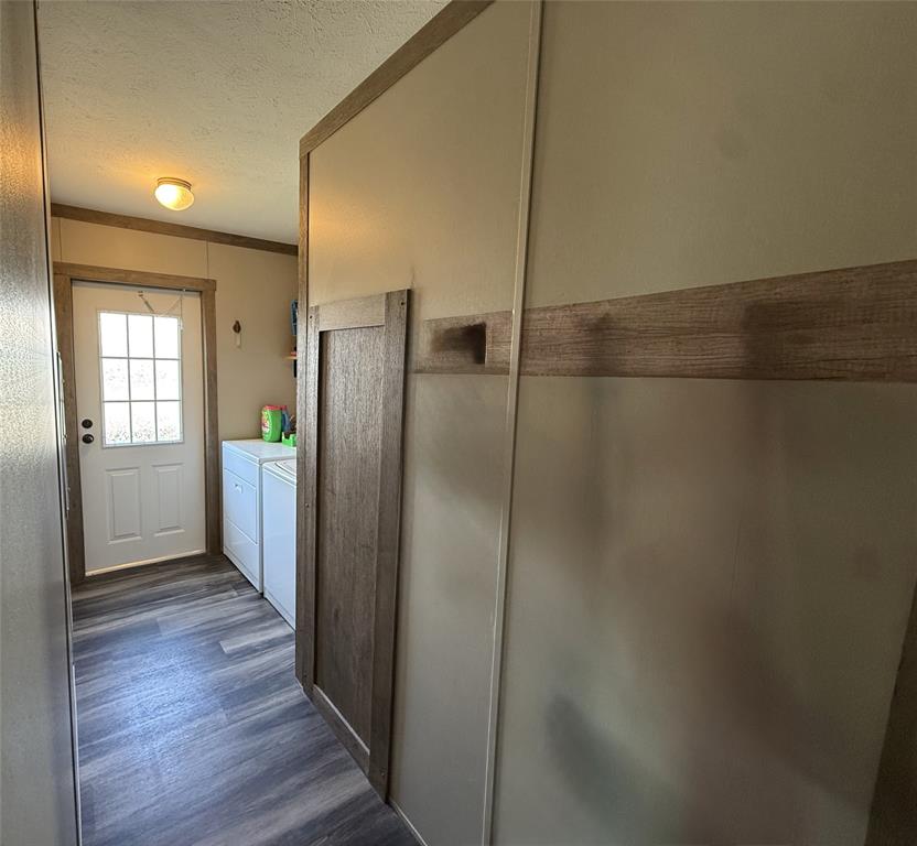 4937 Stuart Road Denton, TX 76207 - Photo 12 of 19 a view of a refrigerator in kitchen and wooden floor