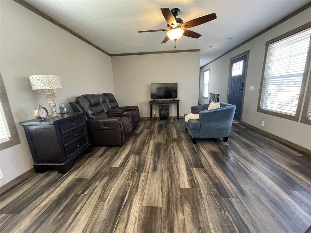 4937 Stuart Road Denton, TX 76207 - Photo 14 of 19 a living room with furniture and a wooden floor
