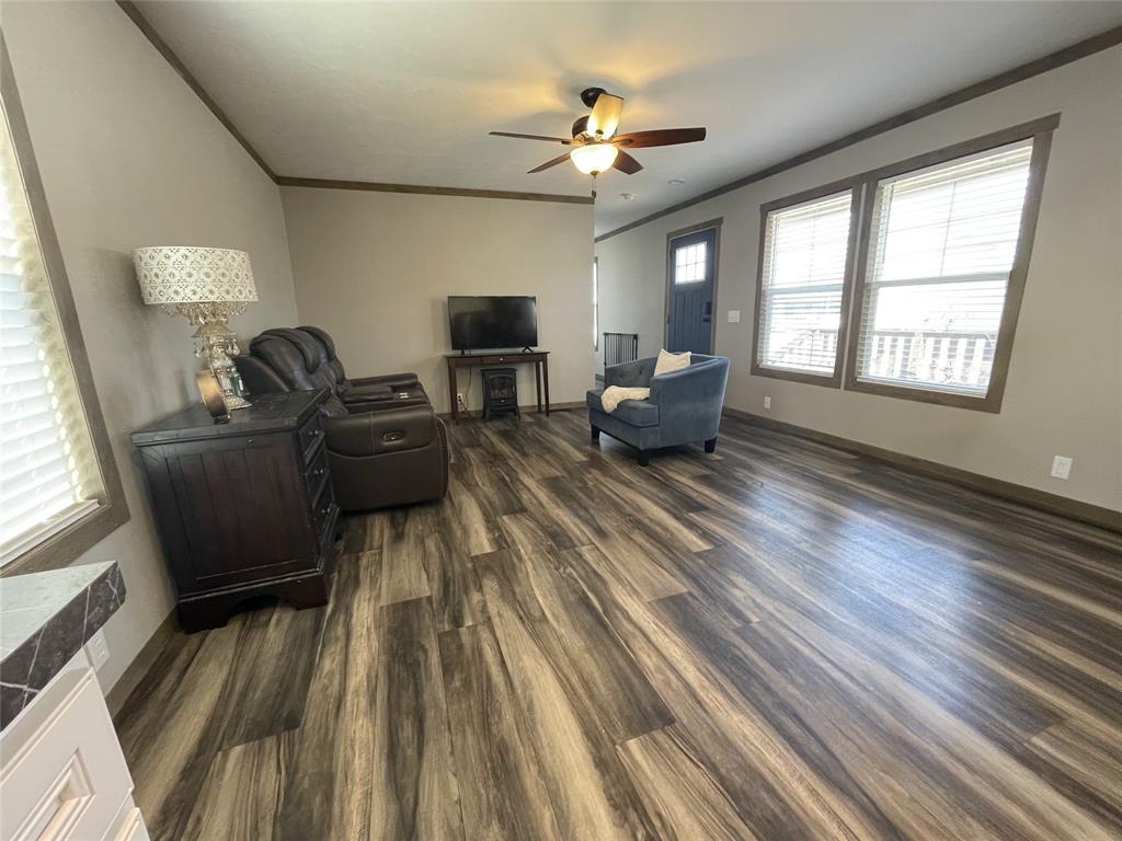 4937 Stuart Road Denton, TX 76207 - Photo 6 of 19 a living room with furniture and a wooden floor