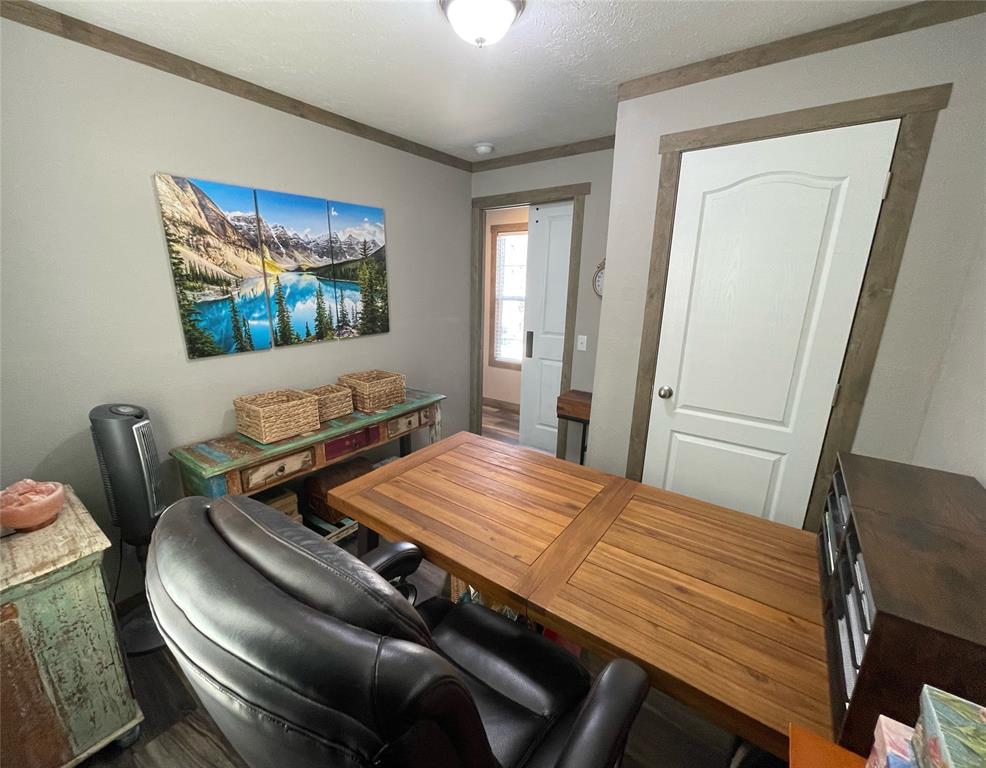 4937 Stuart Road Denton, TX 76207 - Photo 7 of 19 a bedroom with furniture and a flat screen tv