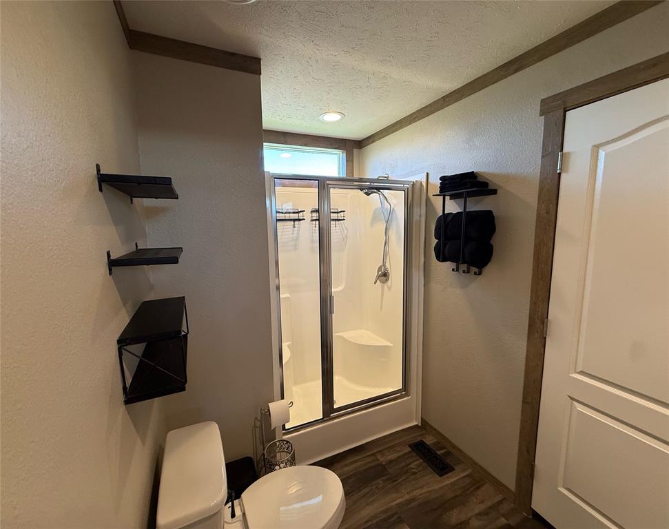 4937 Stuart Road Denton, TX 76207 - Photo 9 of 19 a bathroom with a toilet and a shower