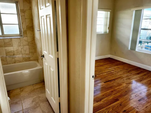a bathroom with a bathtub and window
