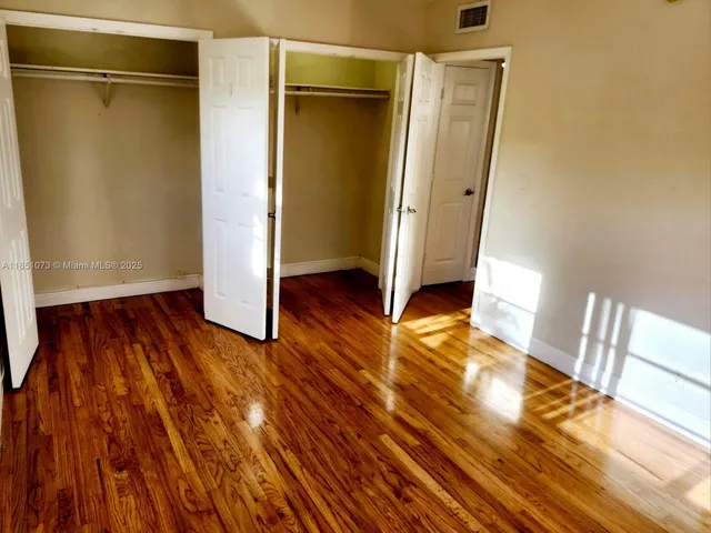 a view of a room with wooden floor and a sink