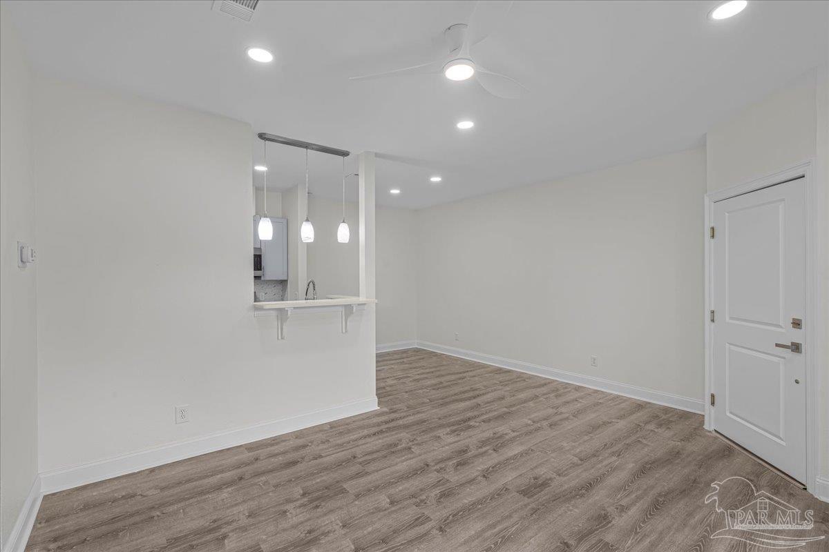 601 East Burgess Road, Unit C3 Pensacola, FL 32504 - Photo 18 of 35 wooden floor in an empty room with a window