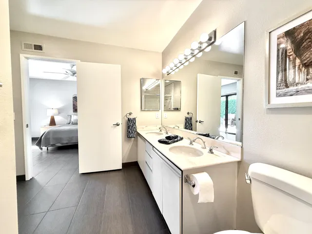 a bathroom with a sink a toilet and a mirror