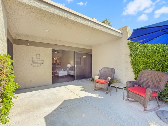 a balcony with furniture and a potted plant