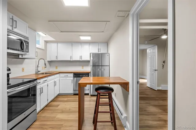 a kitchen with stainless steel appliances granite countertop a refrigerator and a stove top oven