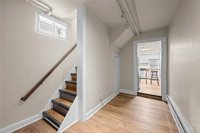 a view of an entryway with wooden floor and stairs