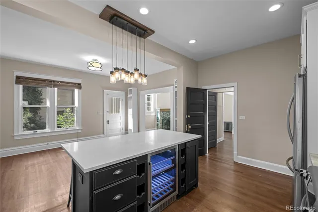 an open kitchen with a table and refrigerator