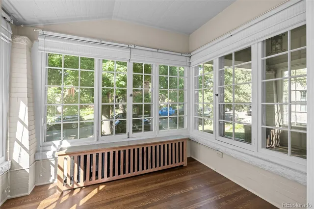 an empty room with furniture a fireplace and wooden floor