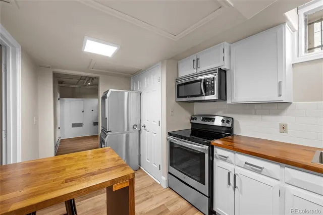 a kitchen with stainless steel appliances a stove microwave and refrigerator