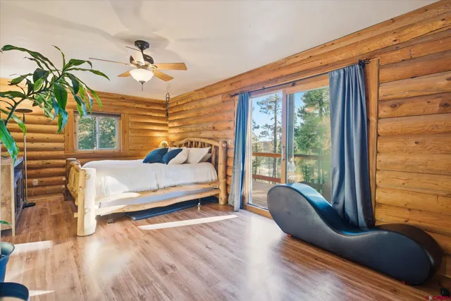 a living room with furniture and large windows