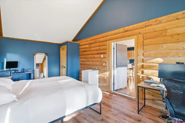 a bedroom with a bed and a large window