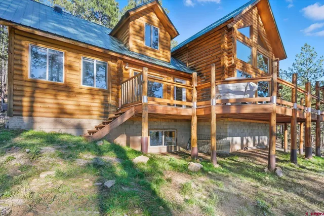 a view of outdoor space with deck and tall trees
