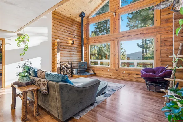 a view of patio with couches table and chairs with wooden floor