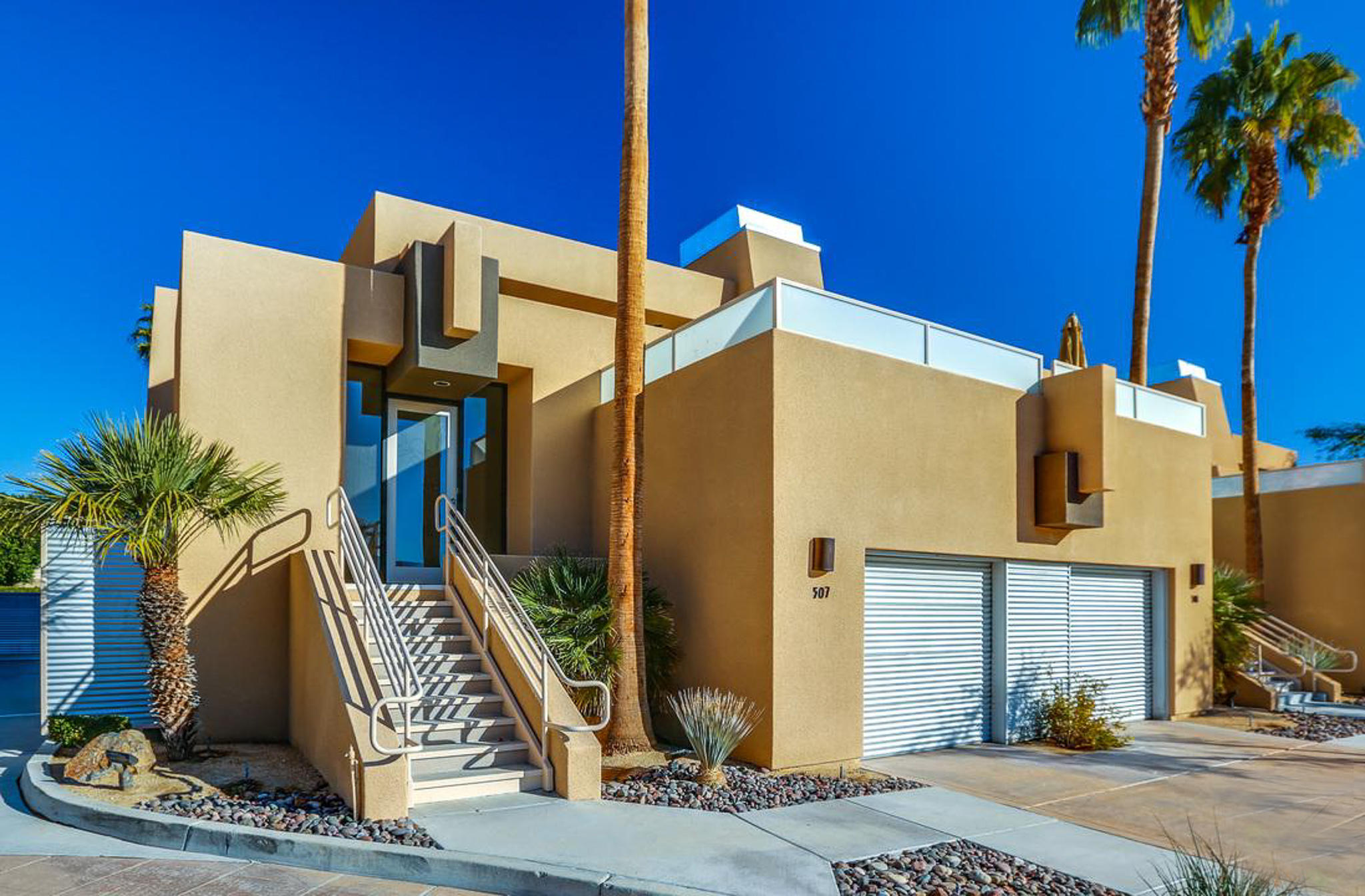 100 East Stevens Road, Unit 507 Palm Springs, CA 92262 - Photo 1 of 25 a front view of a house with palm trees
