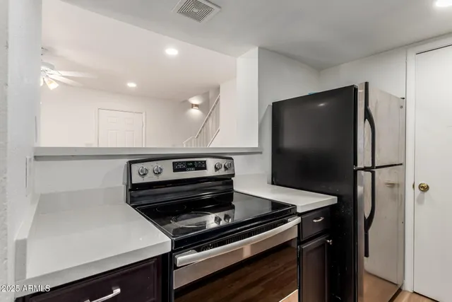 a kitchen with a refrigerator and a sink