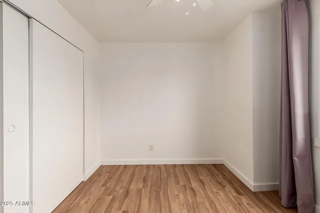 a view of a small space with wooden floor and a window