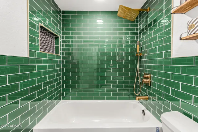 a bathroom with a sink a toilet and bathtub