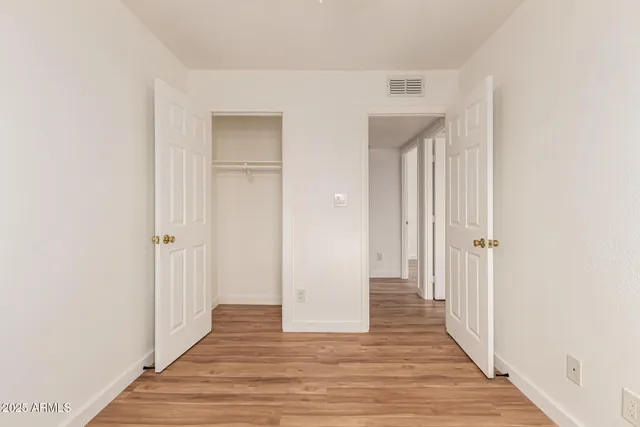 a view of a hallway with wooden floor