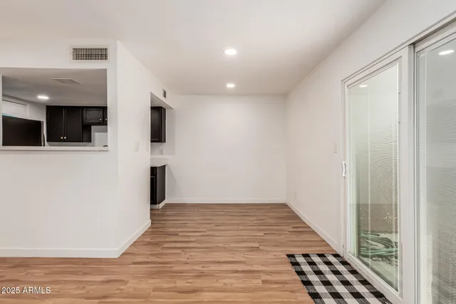 a view of hallway with wooden floor