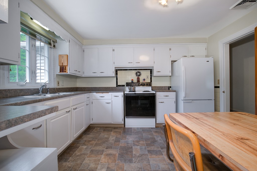 53 Kinnicutt Road Worcester, MA 01602 - Photo 6 of 30 a kitchen with a sink stove and refrigerator