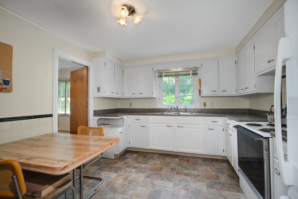 53 Kinnicutt Road Worcester, MA 01602 - Photo 7 of 30 a kitchen with granite countertop a stove a sink dishwasher and a refrigerator