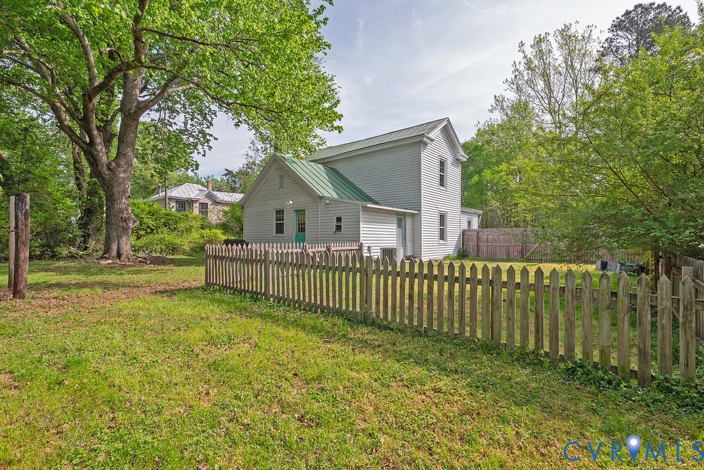 17033 North Telegraph Road Doswell, VA 23047 - Photo 11 of 12 a view of a house with a small yard and a large tree