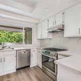 a kitchen with appliances cabinets and a sink