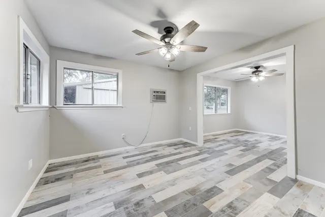 a view of a livingroom with a ceiling fan and window