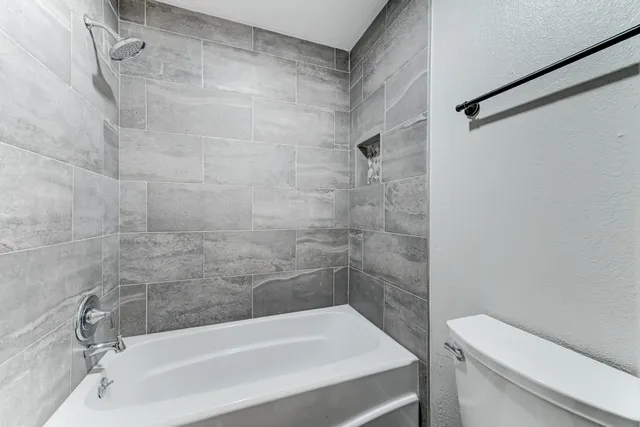 a bathroom with a bathtub and a toilet