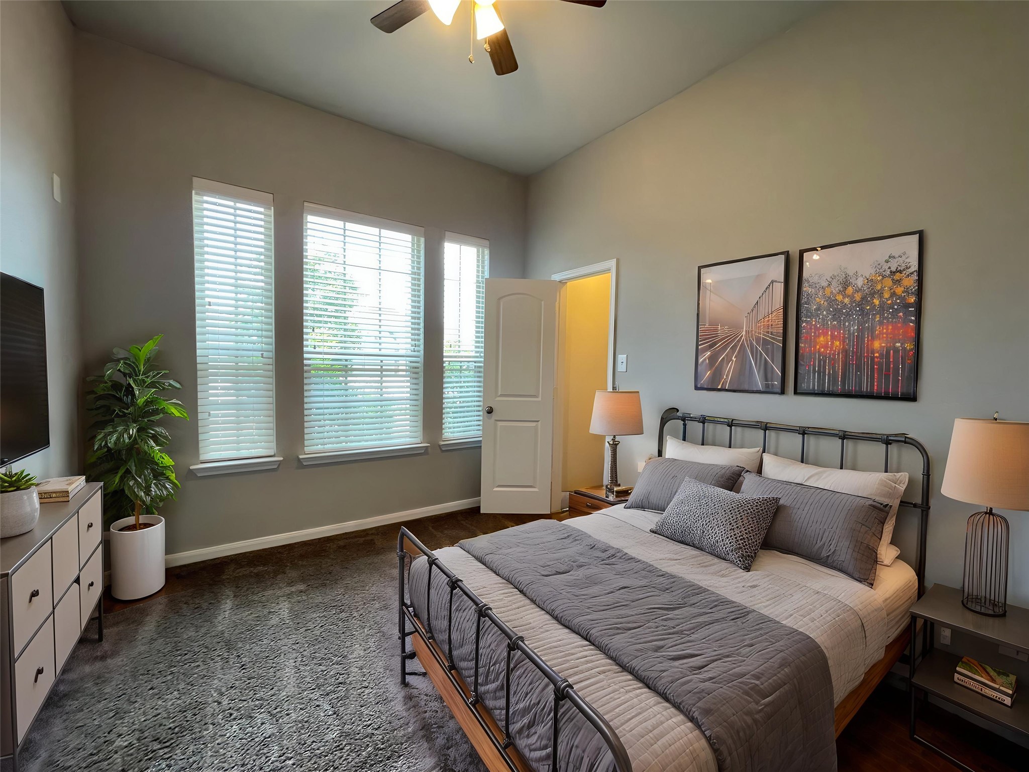 8113 Northgate Loop Temple, TX 76502 - Photo 24 of 35 Room featuring a vaulted ceiling with a ceiling fan, three tall windows with blinds, dark wood-finish flooring, and light gray wall tones