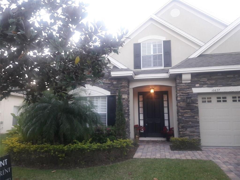 10637 Willow Ridge Loop, Unit 2 Orlando, FL 32825 - Photo 1 of 1 a front view of a house with a yard