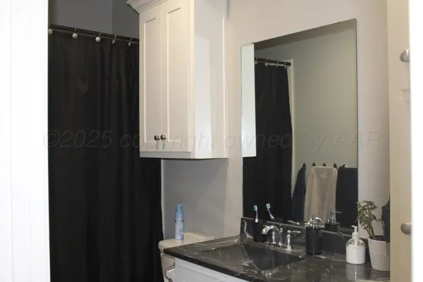 a bathroom with a sink a mirror and cabinets