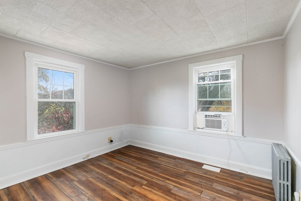 220 Pelham Street Methuen, MA 01844 - Photo 15 of 19 a view of an empty room with wooden floor and a window