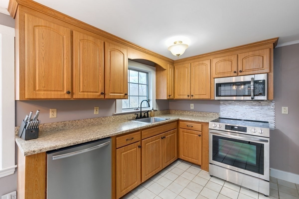 220 Pelham Street Methuen, MA 01844 - Photo 3 of 19 a kitchen with stainless steel appliances granite countertop a stove a sink and dishwasher